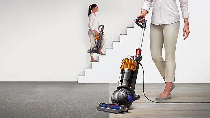 Two Dyson Small Ball Multifloor UP15MF vacuum cleaners with orange cyclone and gray bodies.