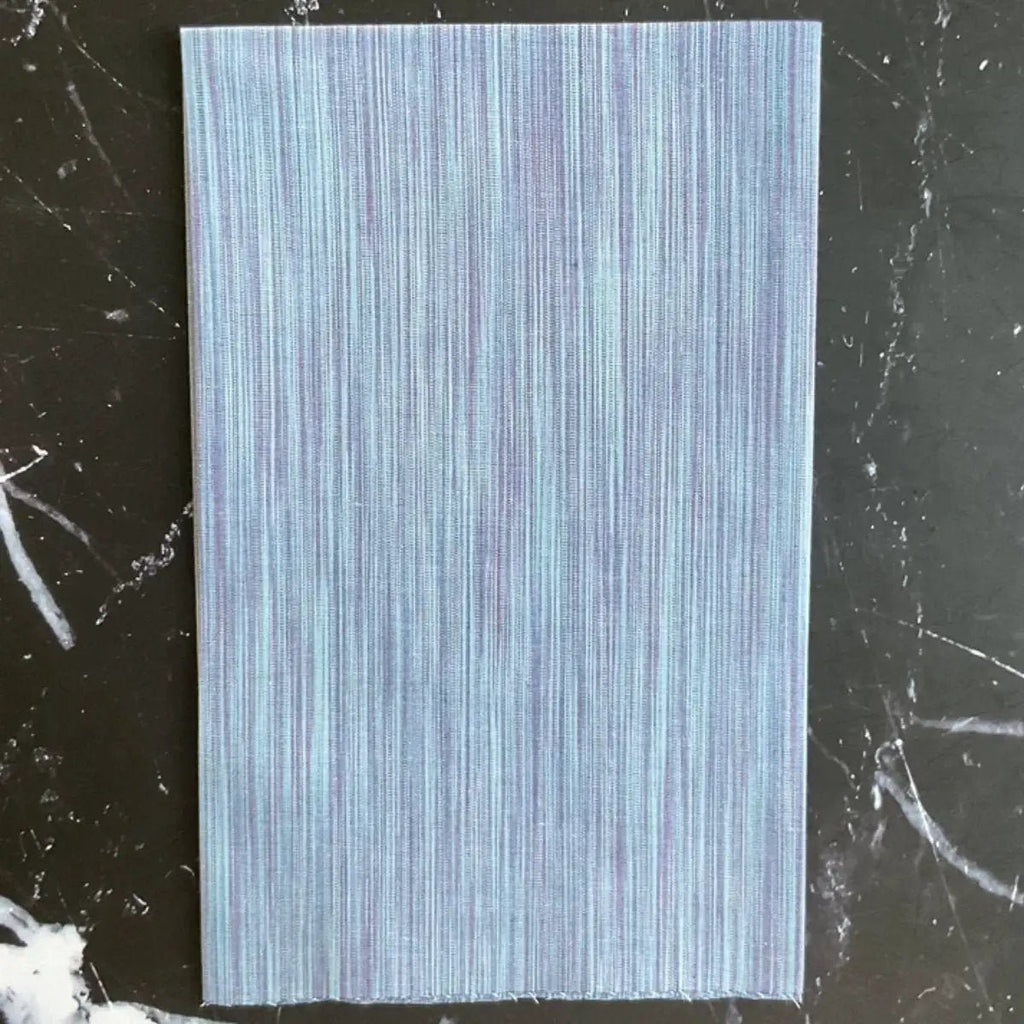Space Dye Cloud yarn-dyed woven cotton fabric with soft blue tonal vertical texture by FIGO Fabrics.
