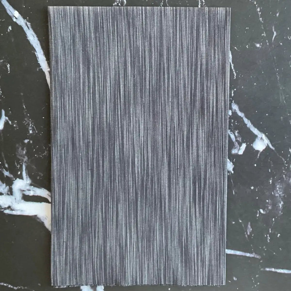 Space Dye Soot yarn-dyed woven cotton fabric with charcoal, black, and smoky gray vertical tonal texture.