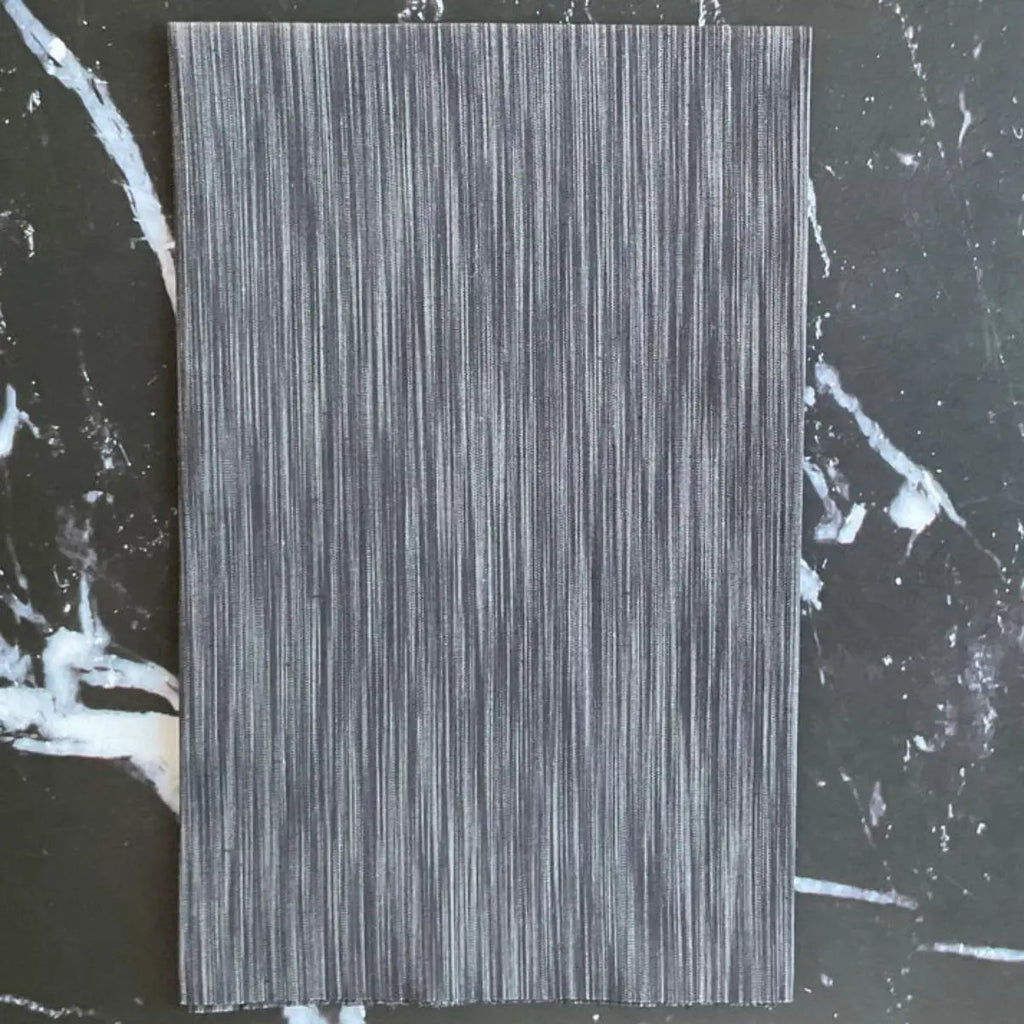 Space Dye Soot yarn-dyed woven cotton fabric with charcoal, black, and smoky gray vertical tonal texture.