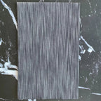 Space Dye Soot yarn-dyed woven cotton fabric with charcoal, black, and smoky gray vertical tonal texture.