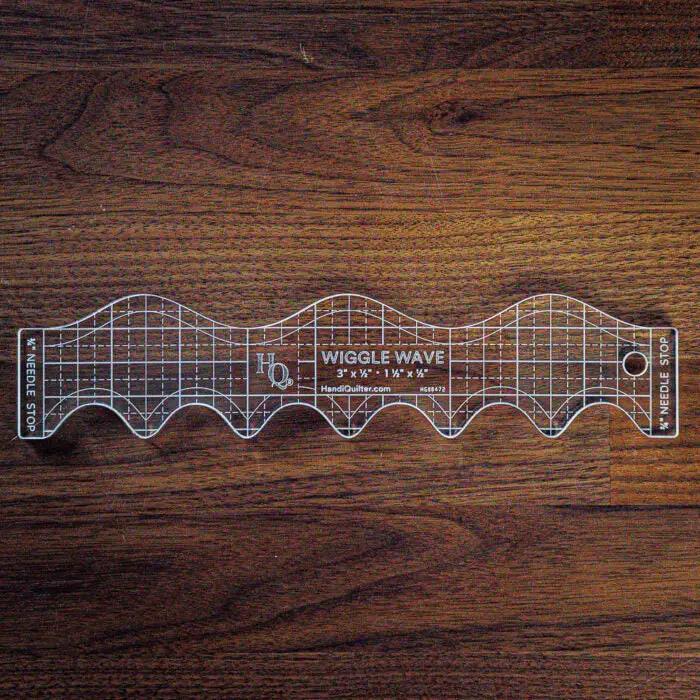 Handi Quilter Wiggle Wave ruler, clear acrylic quilting ruler with grid and wave edges.