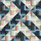 A Quilter's Dream Rockin Rail Fence quilt fabric kit with blue, pink, and neutral prints.