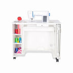 Arrow Mod Sewing Cabinet in white with top-mounted sewing machine and left storage for thread spools on wheels.