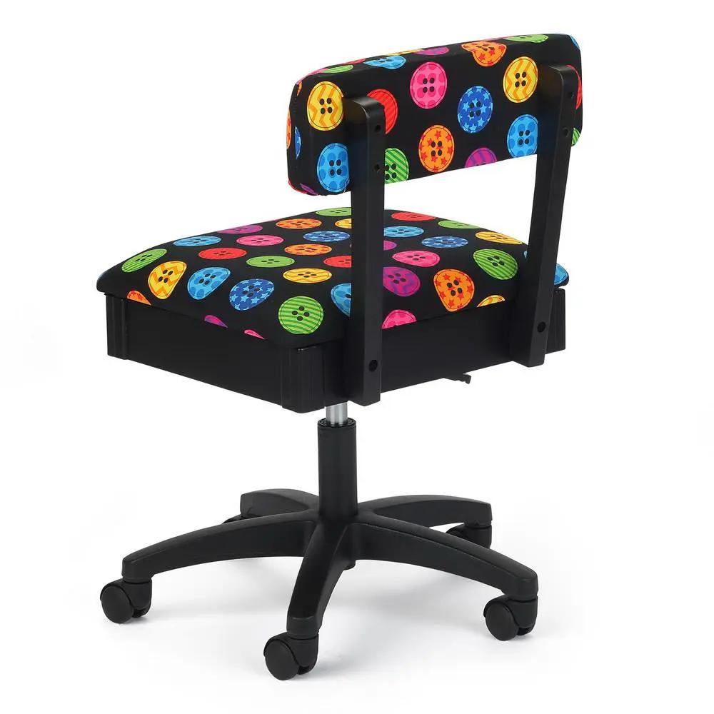 Sewing chair with black frame, five-wheel base, and colorful button-pattern upholstery.