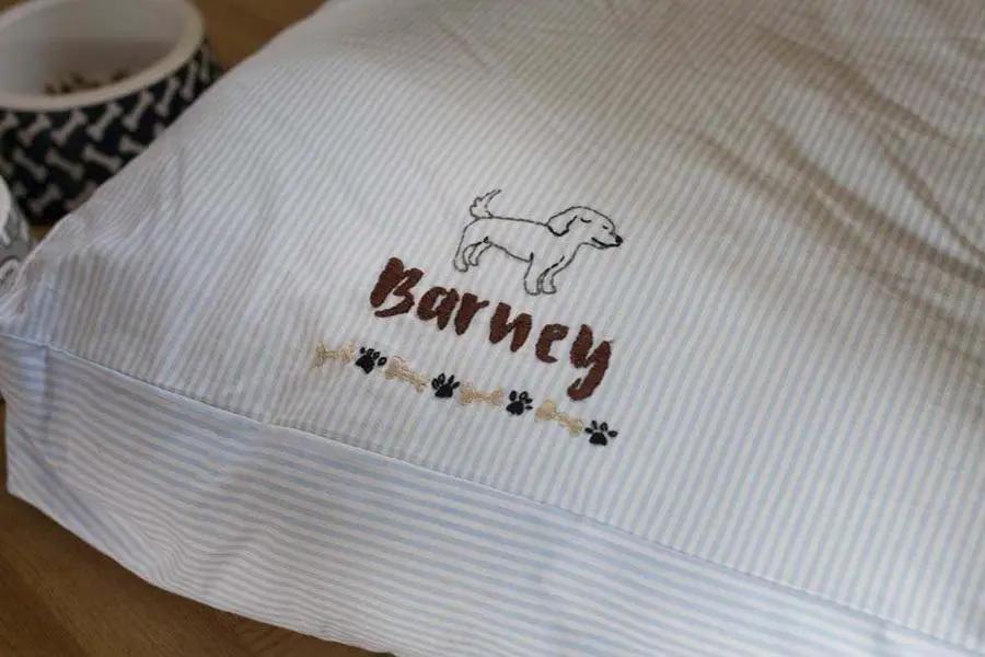 Threaders embroidery transfer sheets - Pets on light blue striped fabric with a dog silhouette and paw accents