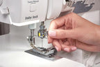 Baby Lock Serenity 4-Thread Serger sewing machine, white body with hand threading.
