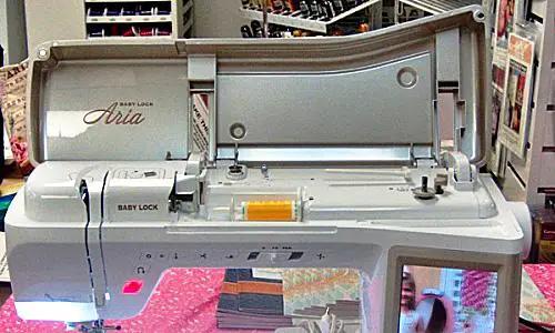 Baby Lock Aria sewing and quilting machine, white and gray with visible Baby Lock branding.