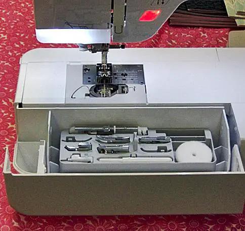Baby Lock Aria sewing and quilting machine, white with open accessory tray and presser feet set