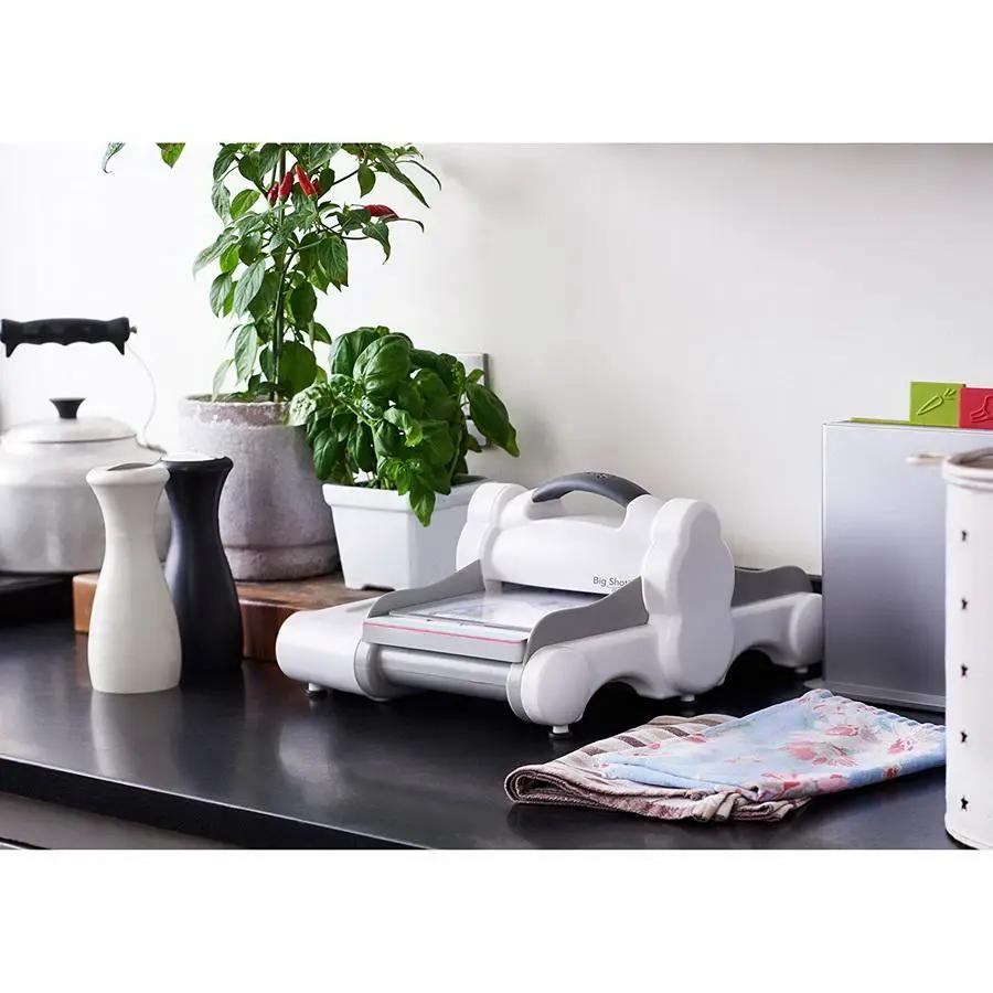 Sizzix Big Shot Express cutting machine in white and gray on a kitchen counter