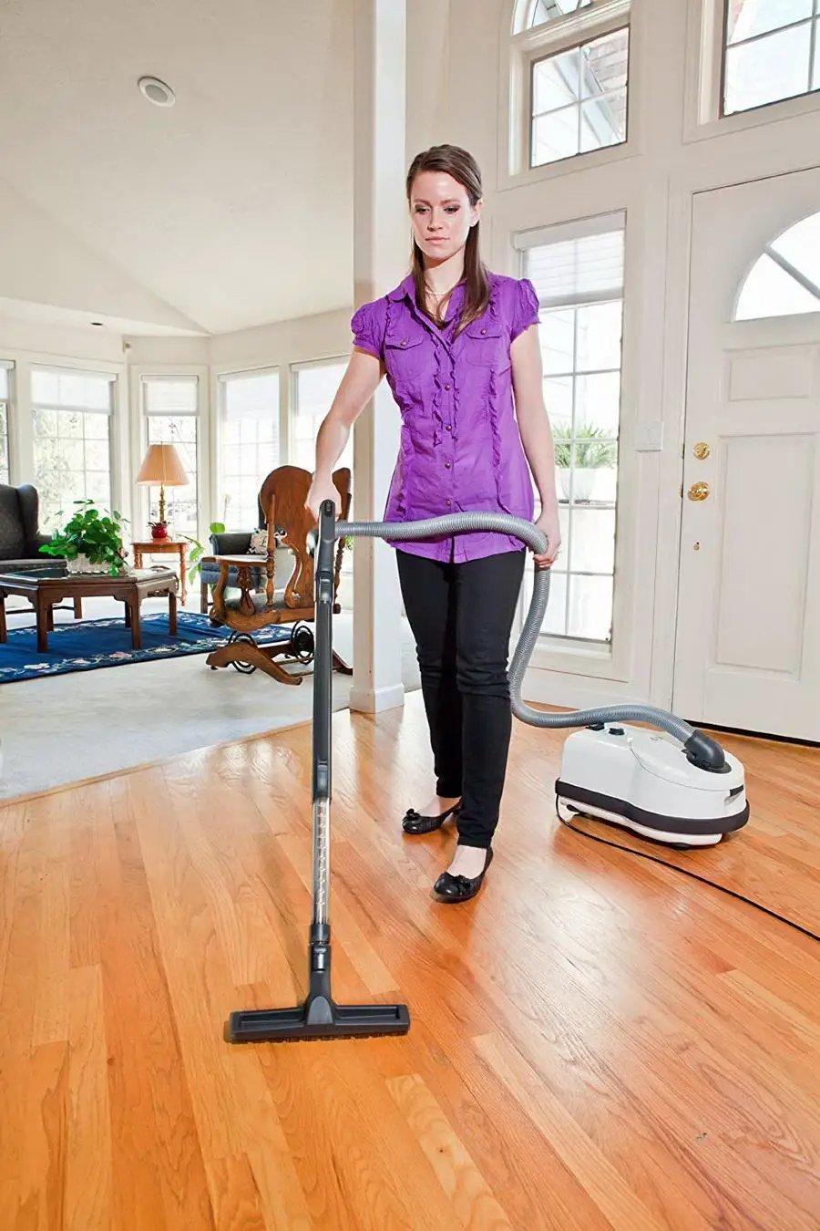 SEBO AIRBELT D4 Premium canister vacuum, white with gray hose and floor nozzle, in a bright living room
