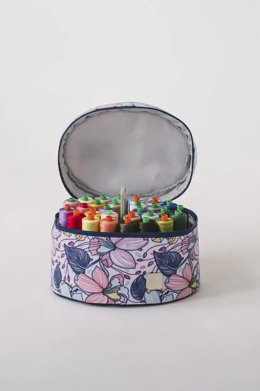 Bluefig Quilter Deluxe Combo bag set; round floral print project bag open to reveal colorful thread spools