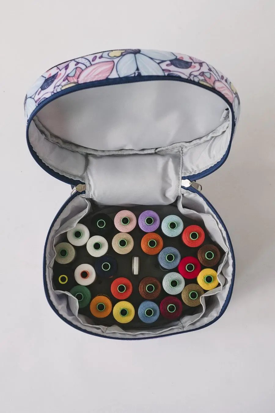 Bluefig Quilter Deluxe Combo bag set in blue floral exterior; features 19-inch wheeled bag and colorful thread spools.