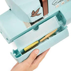 EverSewn Sparrow 30S sewing machine in teal with included extension table and tool drawer.