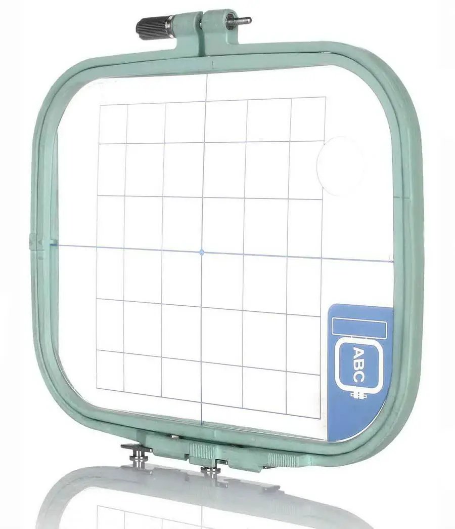 Sew Tech embroidery hoop, 110mm x 110mm, green metal frame with grid interior, ABC label visible