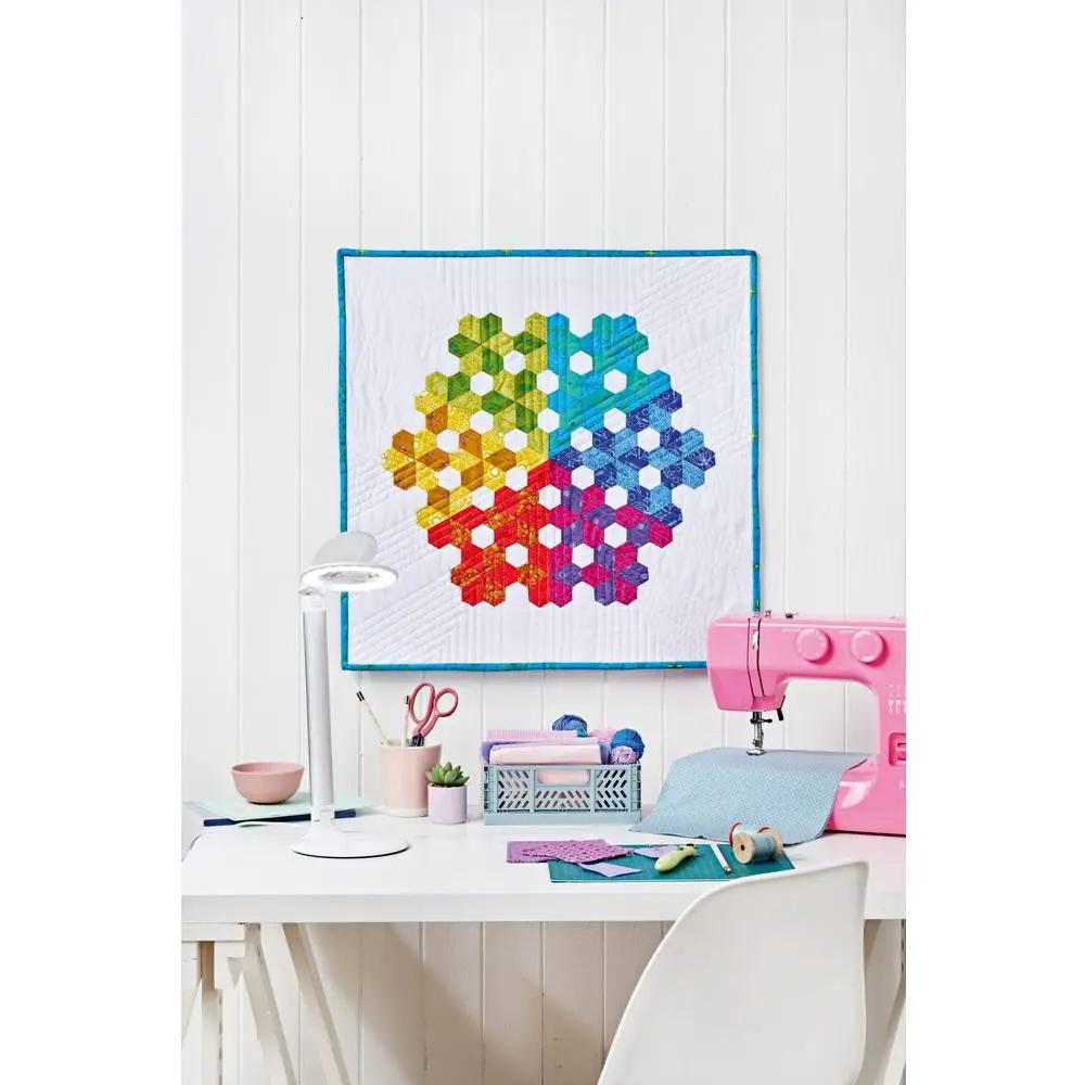 Daylight Halo LED Table Magnifier on white desk with pink sewing machine