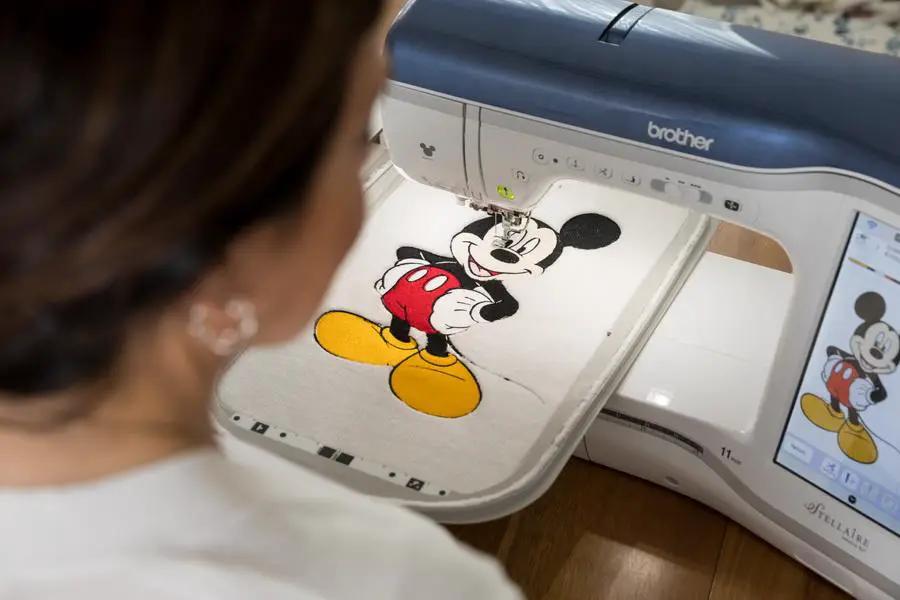 Brother Stellaire Innov-is XJ1 sewing and embroidery machine; embroidering Mickey Mouse on fabric.