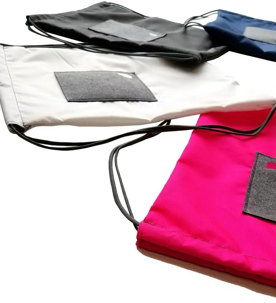 Bluefig Lil Cinch fabric bags set of 4 in pink, white, gray, and black with drawstrings.