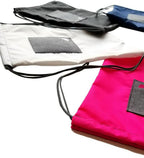 Bluefig Lil Cinch fabric bags set of 4 in pink, white, gray, and black with drawstrings.