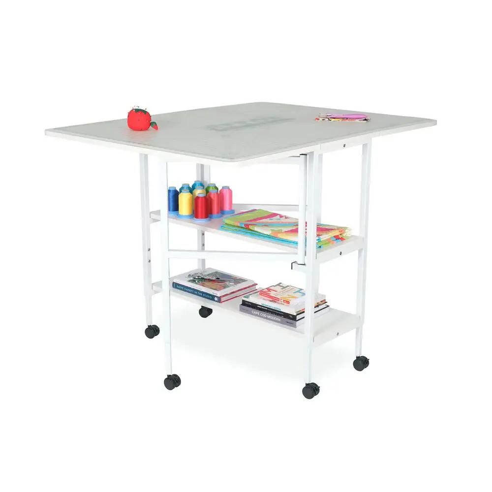 Arrow White Dixie adjustable cutting table on wheels with lower shelves.