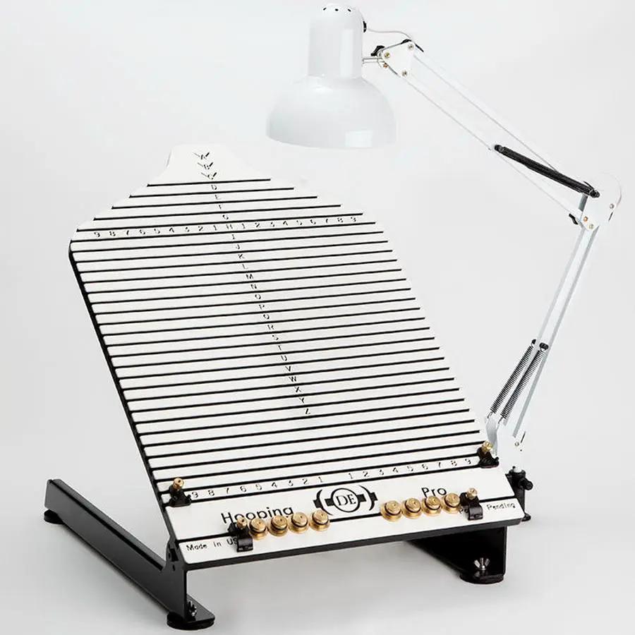 Durkee Hooping Pro Station: white grid board with numbered lines and adjustable desk lamp