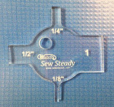 Westalee Spacing Gauge quilting accessory in blue plastic with 1/4 in, 1/2 in, 1/8 in markings and Sew Steady logo.