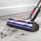 Dyson V8 Animal vacuum head with red button, metallic body and purple brush roller