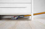 Dyson V8 Absolute SV10 vacuum; orange wand, gray-blue head, bottom-release dust cup.