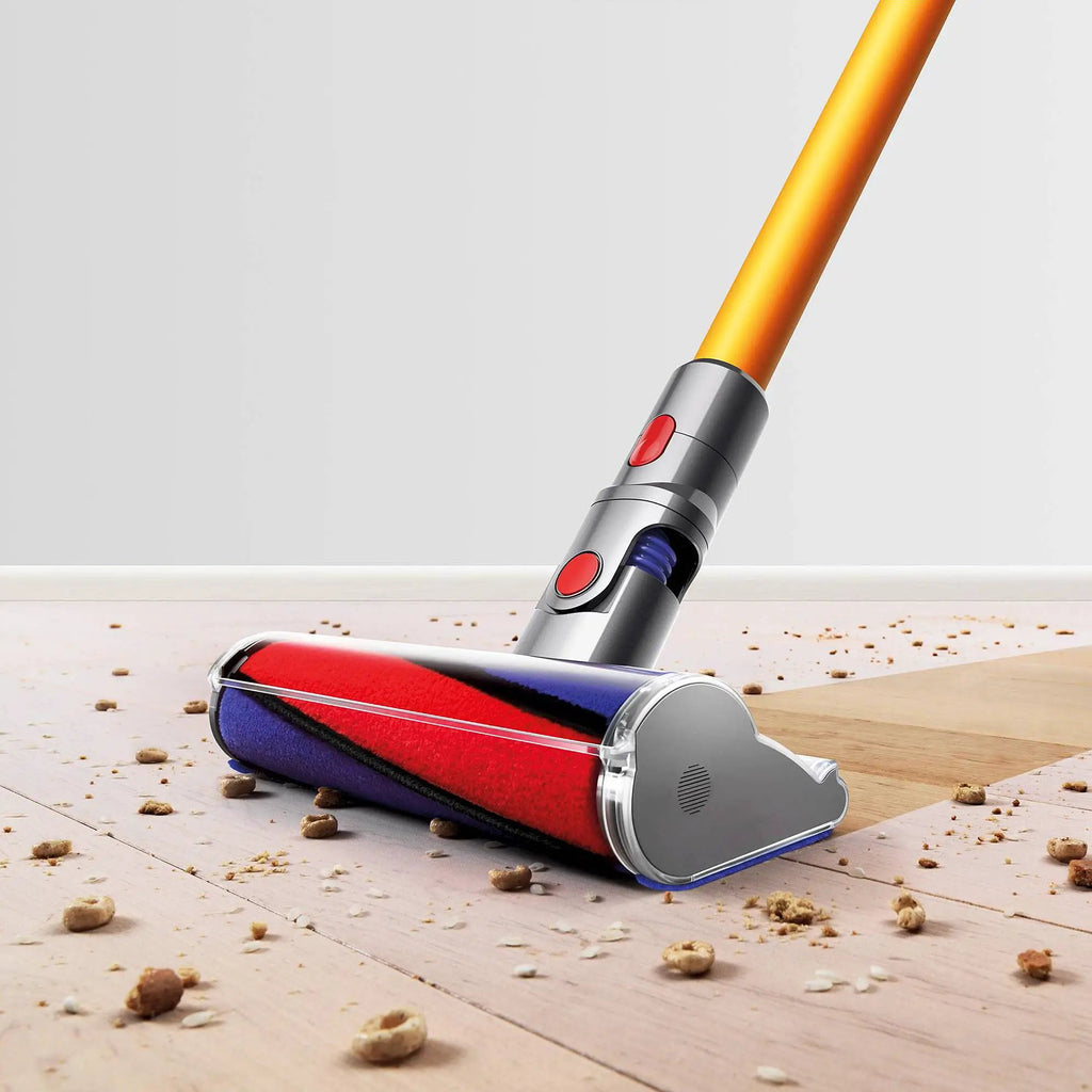 Dyson V8 Absolute vacuum with orange wand, grey body, red controls; bottom-release dust cup visible.