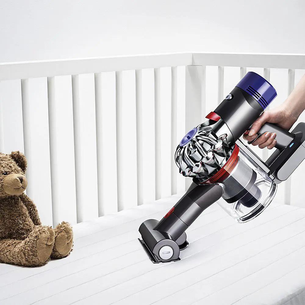 Dyson V8 Absolute vacuum; cordless stick with purple accents and bottom-release dust cup