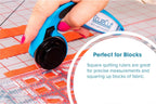 Grace Company TrueCut Original 12.5in x 12.5in quilting ruler, blue, on fabric with a cutting mat.