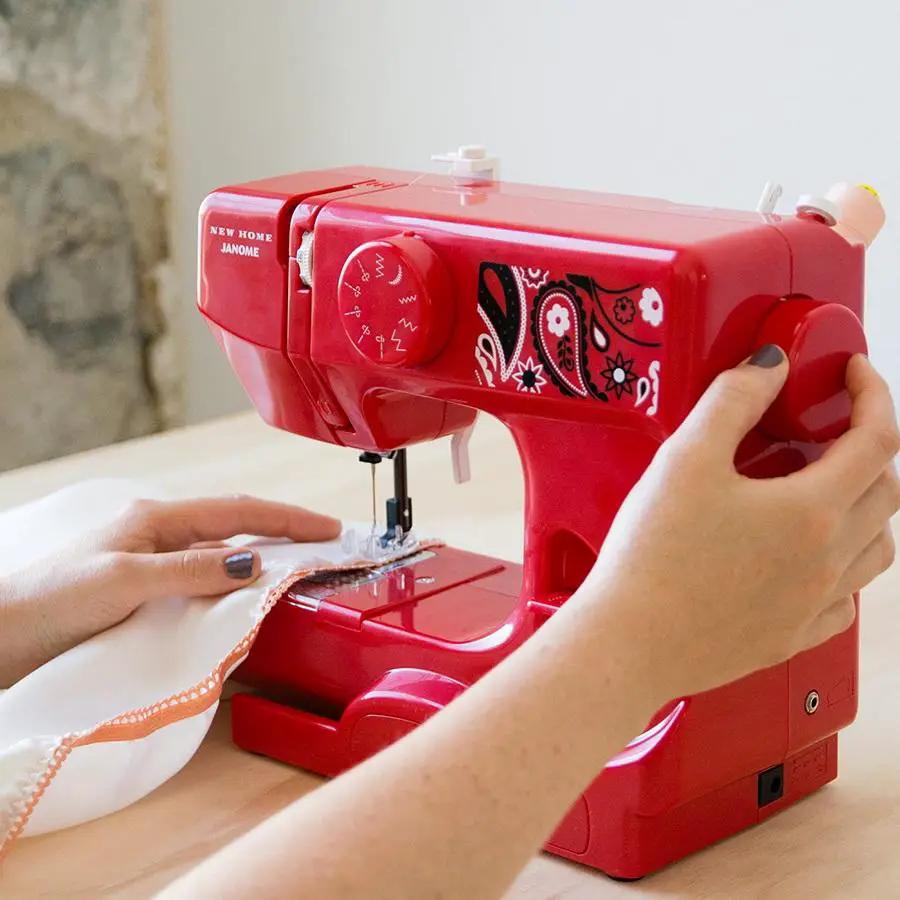 Janome Derby Line portable sewing machine in bandana blush red with white paisley pattern.
