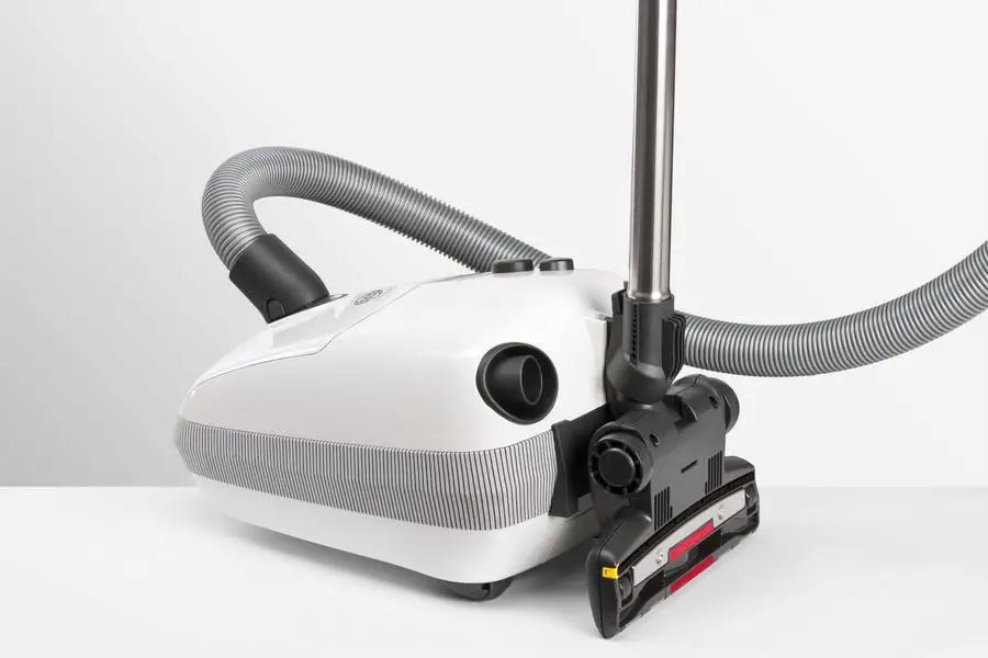 SEBO AIRBELT E3 Premium canister vacuum in Arctic White with gray hose and floor nozzle.