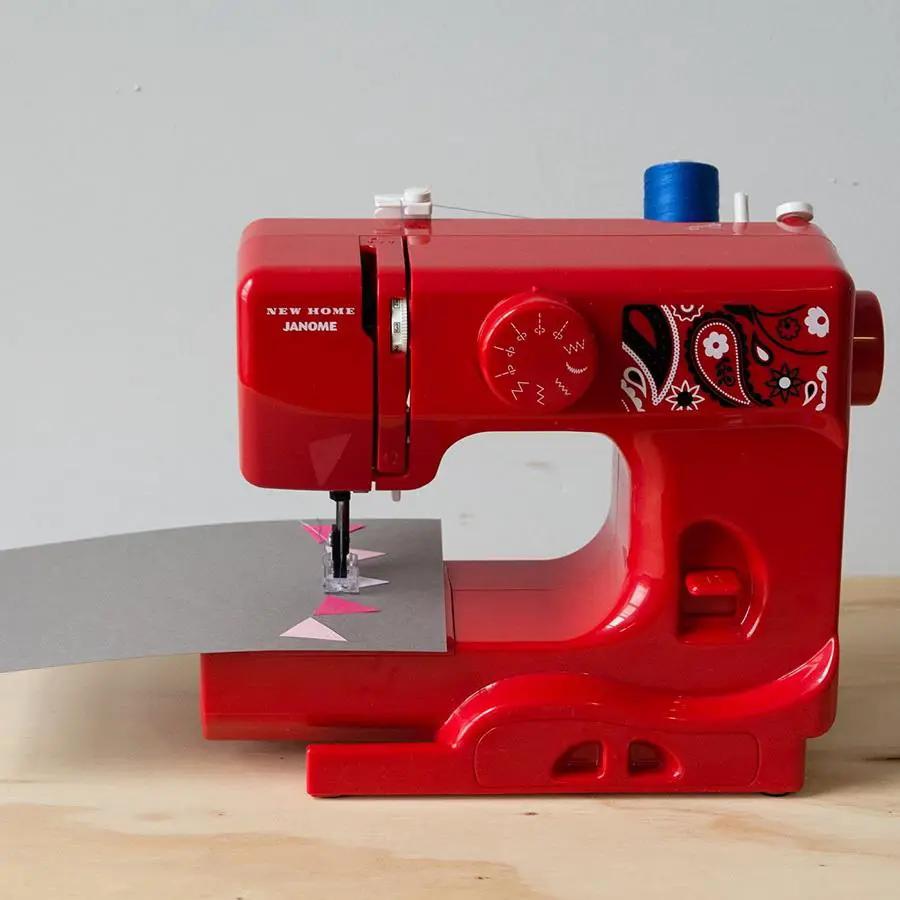 Janome Derby Line portable sewing machine, red with bandana-pattern decal and blue thread spool
