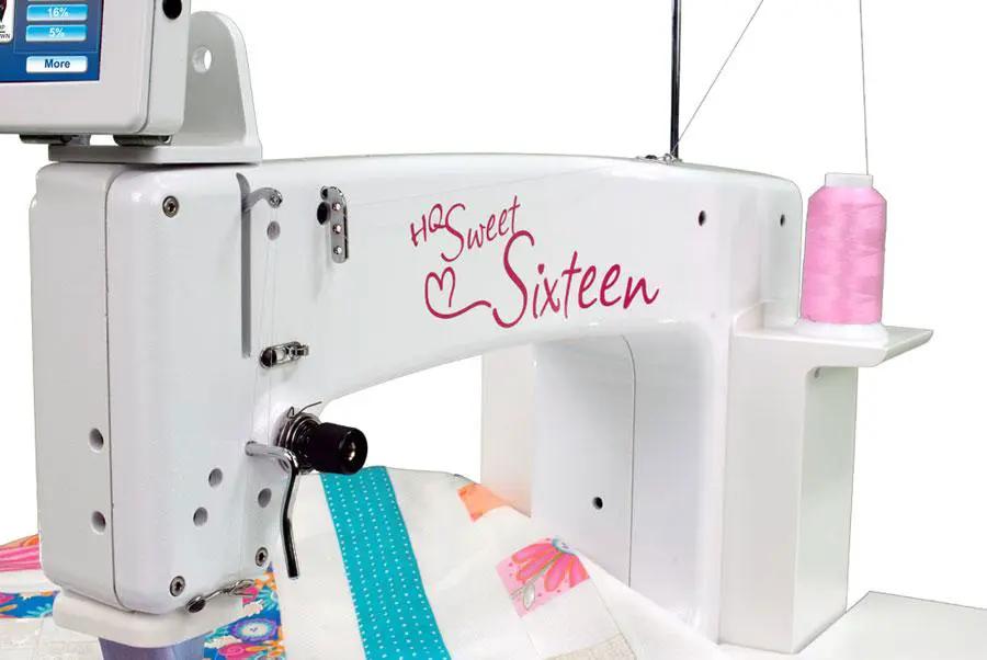 Handi Quilter Sweet Sixteen long-arm quilting machine; white body with pink logo and pink thread spool.