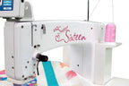Handi Quilter Sweet Sixteen long-arm quilting machine; white body with pink logo and pink thread spool.
