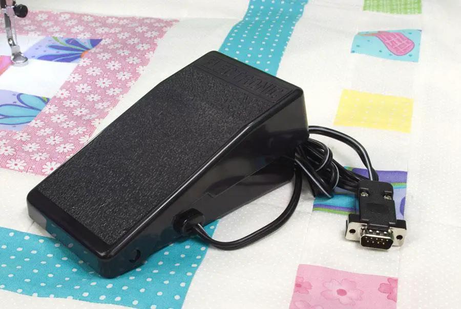 Handi Quilter foot pedal controller for Sweet Sixteen long arm quilting machine, black with coiled cord and DB-9 plug.