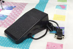 Handi Quilter foot pedal controller for Sweet Sixteen long arm quilting machine, black with coiled cord and DB-9 plug.