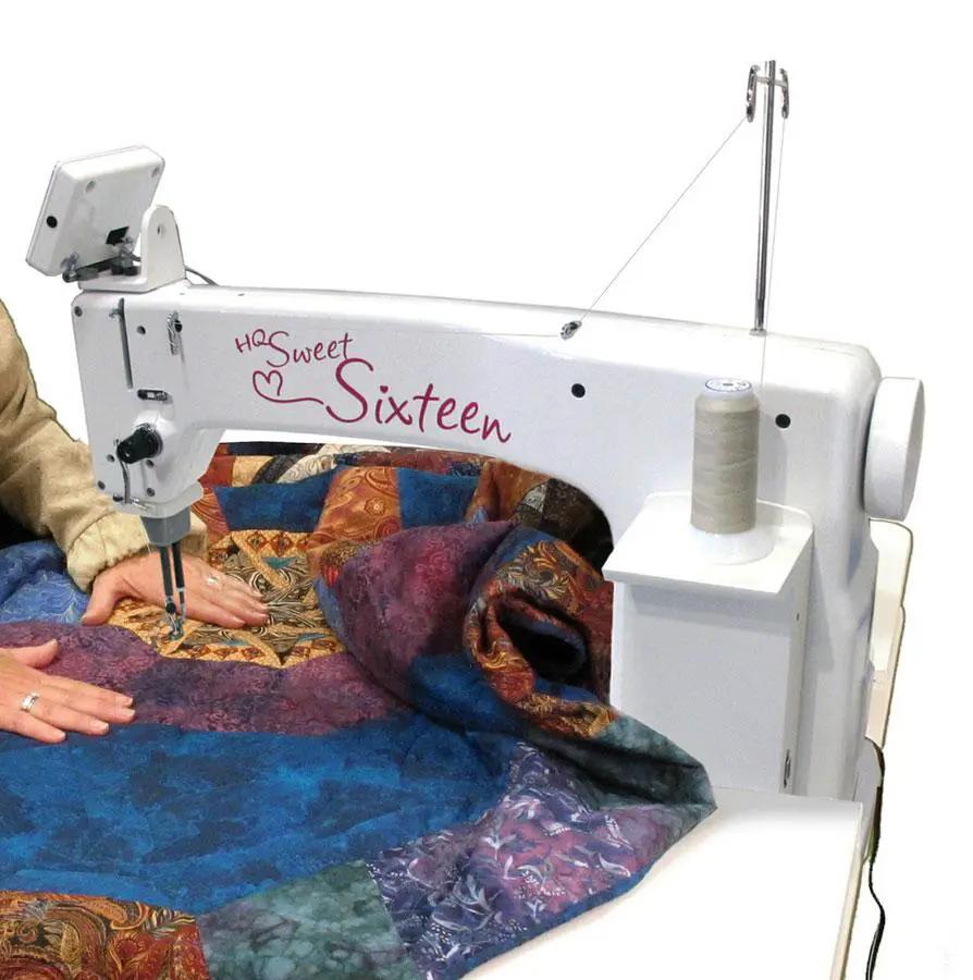 Handi Quilter Sweet Sixteen long-arm quilting machine, white with quilted fabric under the needle