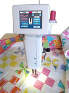 Handi Quilter Sweet Sixteen long-arm quilting machine on stand, white with touchscreen display