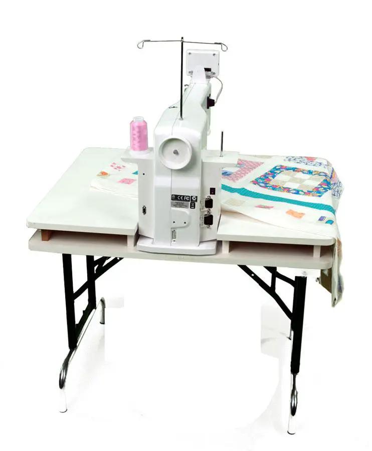 Handi Quilter Sweet Sixteen long-arm quilting machine on white worktable; white body with pink thread spool