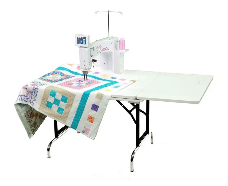 Handi Quilter Sweet Sixteen long arm quilting machine on a black metal frame with white table extension