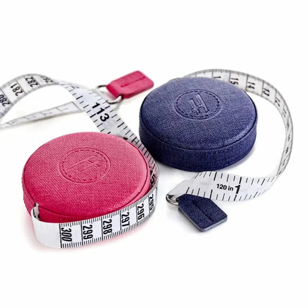 Hemline 120in retractable tape measure, two pink and blue cases with white tape.