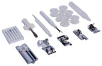 Janome sewing machine accessory kit featuring multiple presser feet, bobbins, needles, screwdrivers, and rulers.