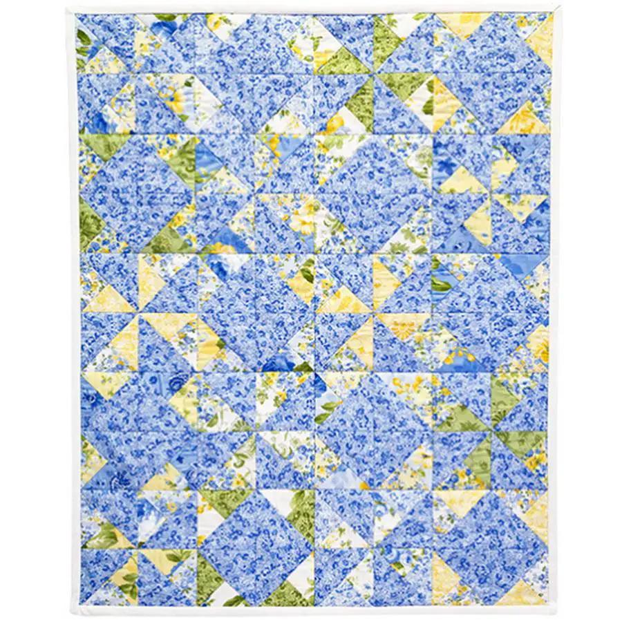 Charm Pack Quilt Blocks quilt top in blue floral and yellow patchwork by Anita Goodesign