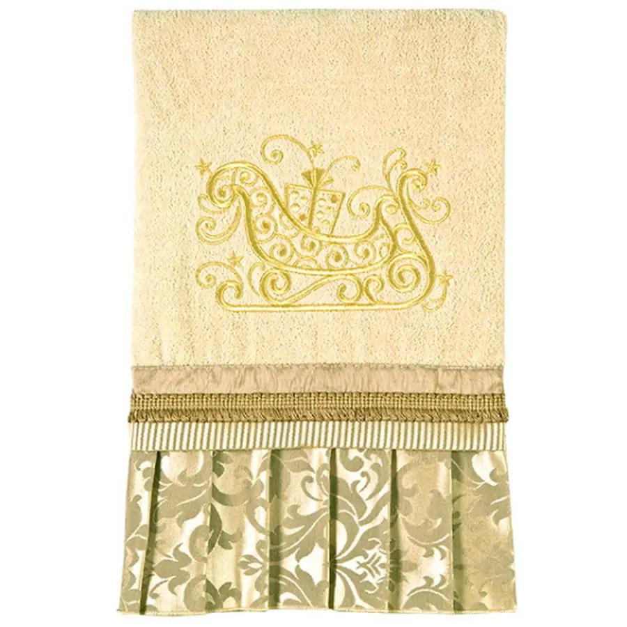 Anita Goodesign Christmas Curls 115MAGHD embroidery design on beige linen with gold sleigh motif and decorative fringe.