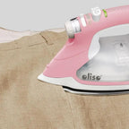 Limited Edition Oliso Pro TG1600 pink smart iron on beige fabric, Oliso branding visible.