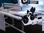 Handi Quilter Gallery2 Frame QuiltMaster DuoLoad Sidearm Upgrade Kit mounted on a quilting frame with fabric loaded.