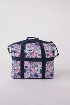 Bluefig Quilter Deluxe Maisy bag in floral purple print with navy straps.