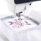 Sew Tech 120x120mm embroidery hoop, white, with purple floral embroidery on an embroidery machine